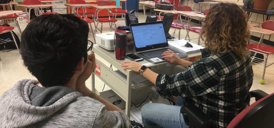 Multimedia teacher Karen Robinson and junior Garret Calusdian work diligently to create high quality content for Lancer Spirit Online. 
