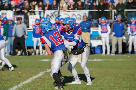 Quarterback Jake McEachern hands the ball off to running back Jeff Wiedenfeld. The Lancers defeated Salem in the Division One Semifinals and advanced to the state championship.