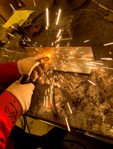 Senior Blaine Hopkins welds a project together in metals class. 