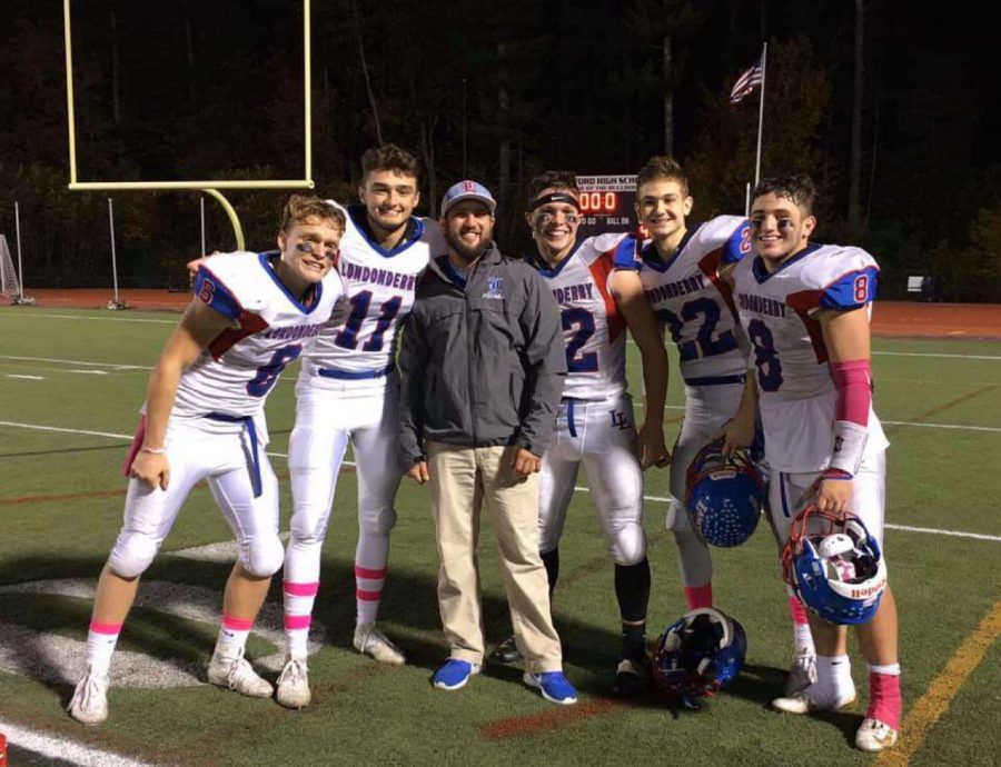 Lancer defenders pose with defensive coordinator, Coach Clement. The Lancers completed an undefeated season with a dominant defense led by Clement.