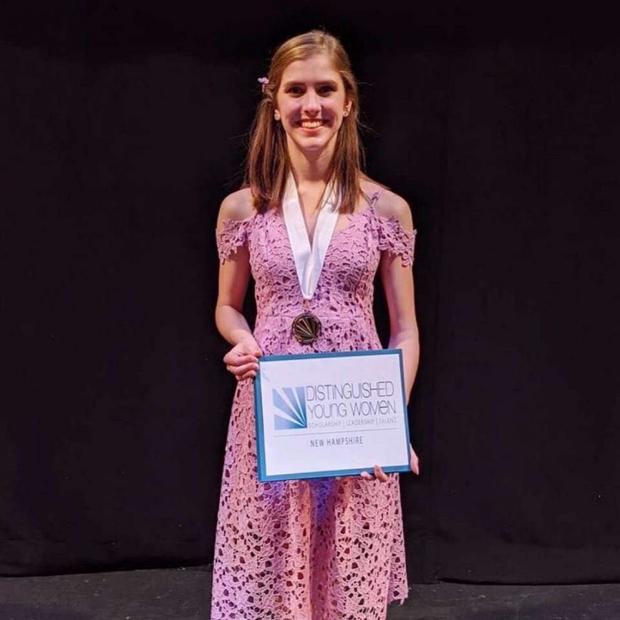 Mauceri poses on stage with her award after her big win.