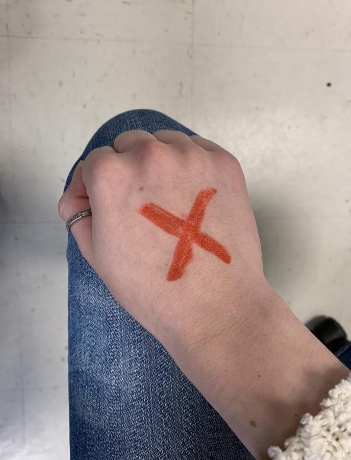 Draw a red X on either hand and wear jeans to create awareness of human trafficking. 
