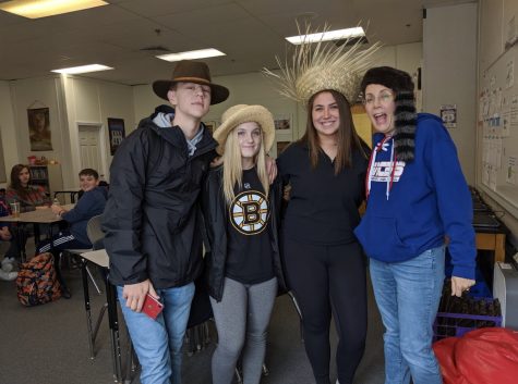 Mrs.Juster poses with a few students on crazy hat day during spirit week. 