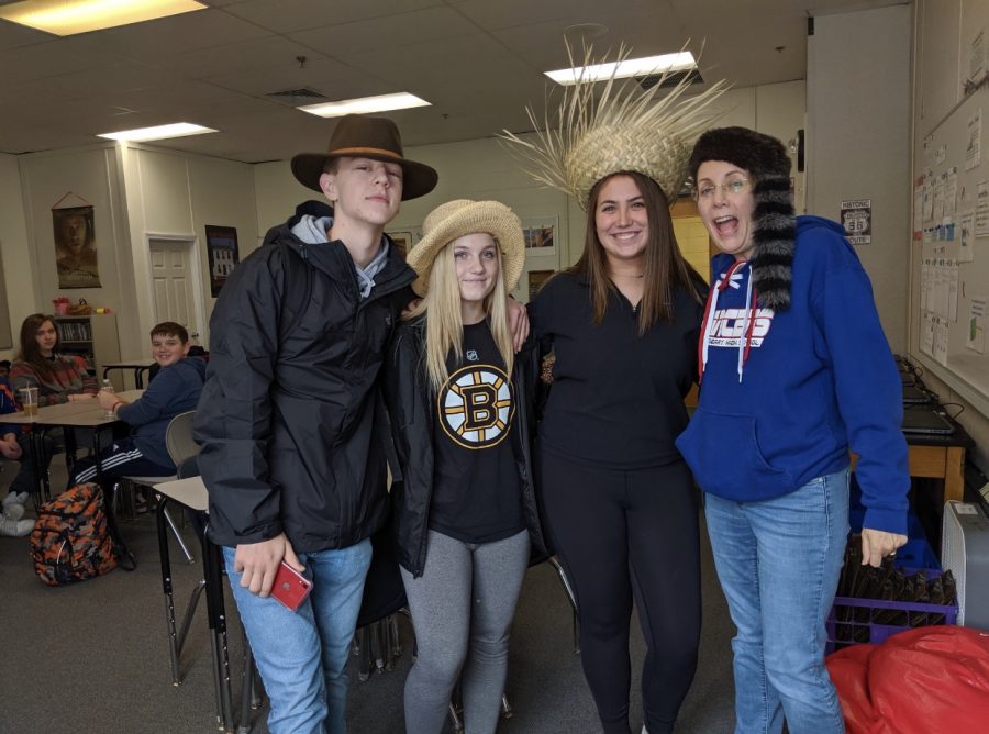 Mrs.Juster+poses+with+a+few+students+on+crazy+hat+day+during+spirit+week.+