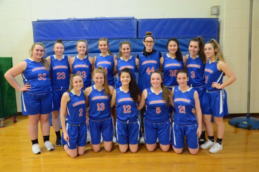 The girls varsity basketball team poses for a team photo. They take on Goffstown in the semifinals on Thursday.
