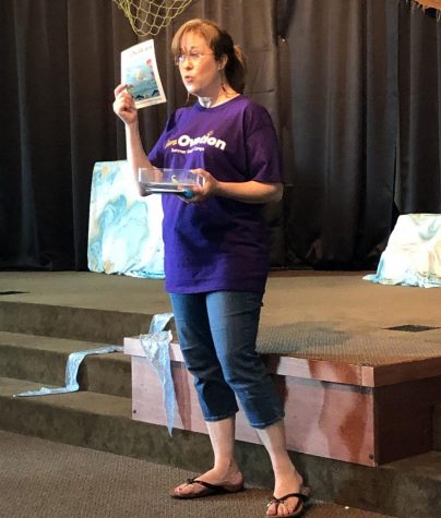 Meg Gore speaks to an audience of families and friends who came out to see the performance of The Journey of the Noble Gnarble last summer. This show was the culminating event after the five-day theatre camp hosted by Gore's new theatre company, Ovation.