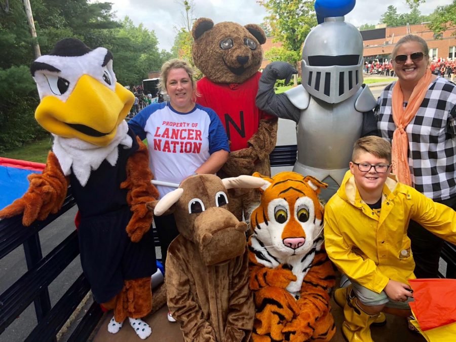 Katie Sullivan volunteers to bring mascots to the Londonderry Old Home Day Parade alongside Ms. Small (upper right) and a student volunteer from LMS (bottom right). 