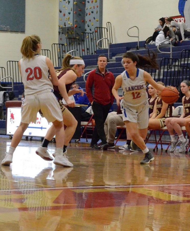 Senior Katie Sullivan dribbles ball during a home basketball game. 