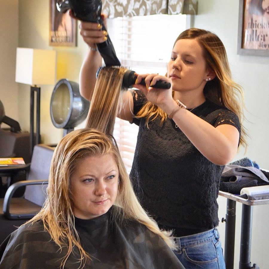 Fliger works her magic as she styles a clients hair. 