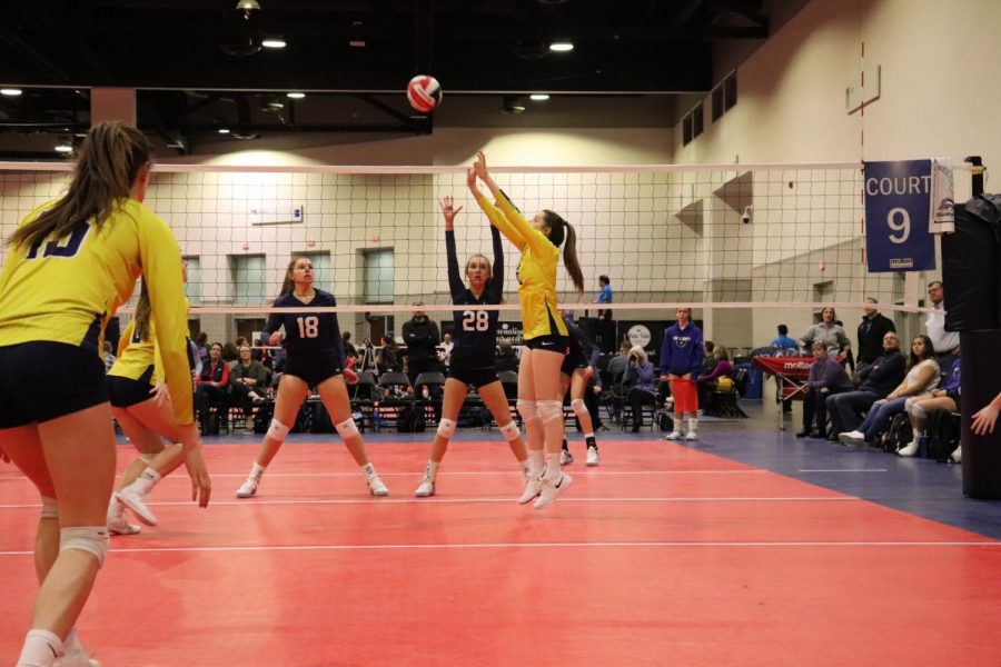 Haas sets the ball at her club volleyball tournament in Providence, Rhode Island. Haas looks forward to this tournament every year because of the intense competition. 