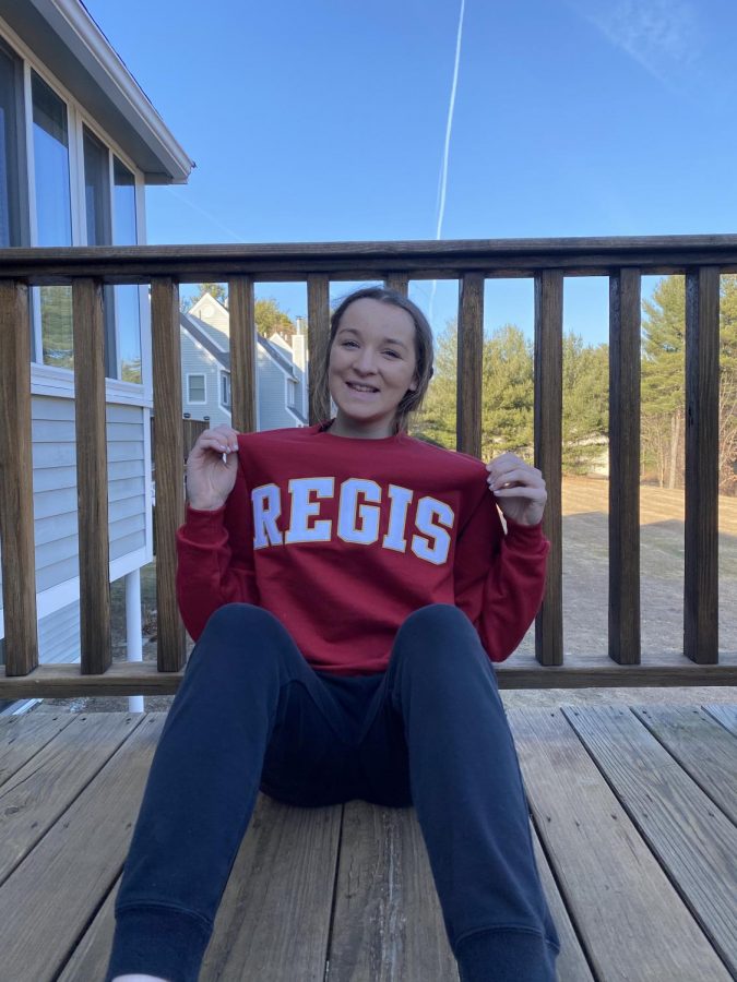 Haas shows off her Regis College shirt.