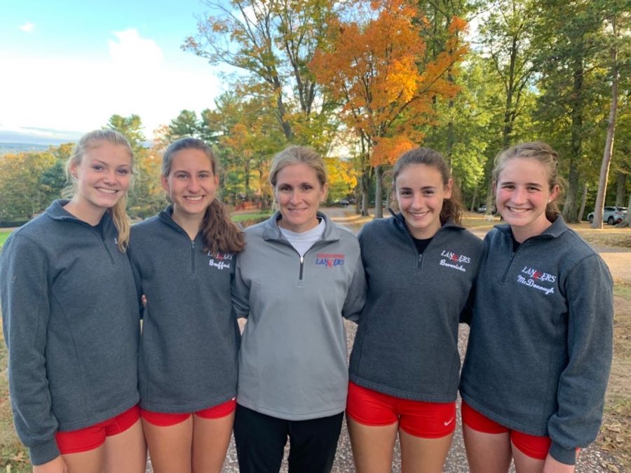 Senior cross country girls with Mrs. Sanborn after their final meet for the fall season.