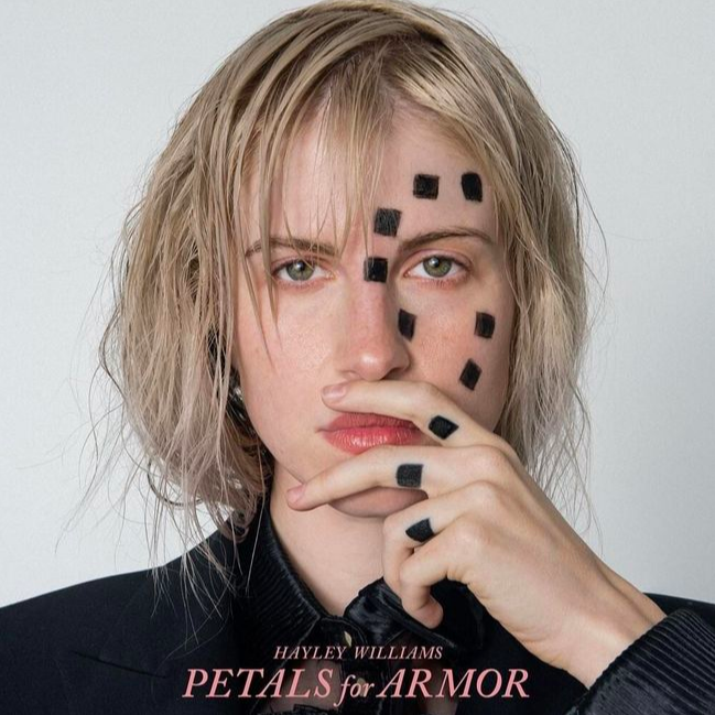 Williams poses for the album artwork of 'Petals For Armor.' Williams originally had Gilbert's initials tattooed on her fingers, but after their divorce, she covered them up with the three squares.