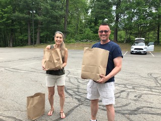 Two volunteers from Londonderry Christian Church help bring bags out to the families in need during their “every two week” pick up drive-thru on Thursdays.