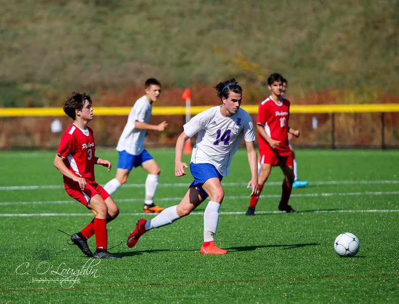 Hunter Smith running towards the ball in game against Pinkerton.