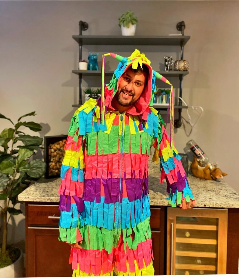 Spanish teacher Rodrigo Rosa-Blackburn shakes his crepe paper during his dance in a piñata costume as the winner of this years contest put on by the Drama Club.