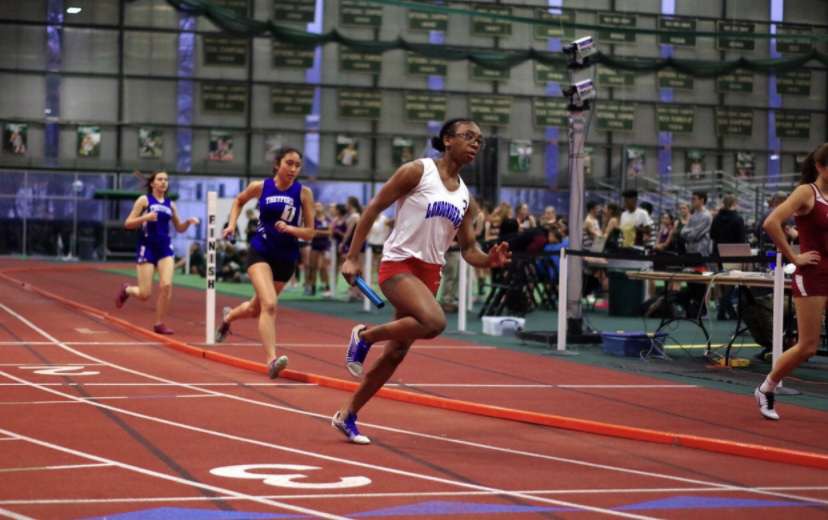 Senior Erica Waters takes a good position in her team relay against rival teams Salem, Pinkerton, and Timberlane. This is one of few events Waters takes part in.
