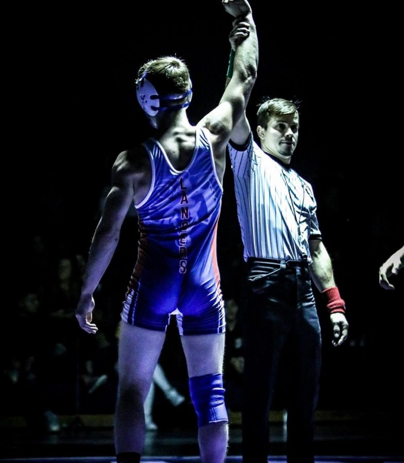 Senior Dylan Barnes is announced the winner of his match which was won under the lights. This was one of many wins for Barnes in his very hardworking and successful season.
