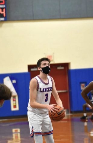 Senior Brian Gould focuses on the hoop as he readies himself to take a free throw