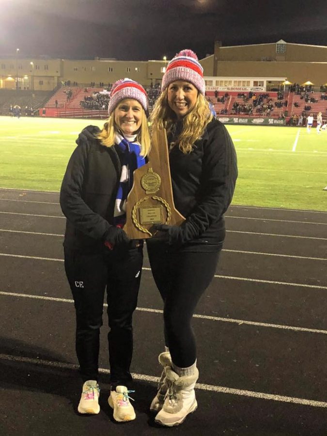 Unified coach Mrs. Tebbetts holds the the Unified soccer championship plaque alongside assistant coach Colleen Ellis.