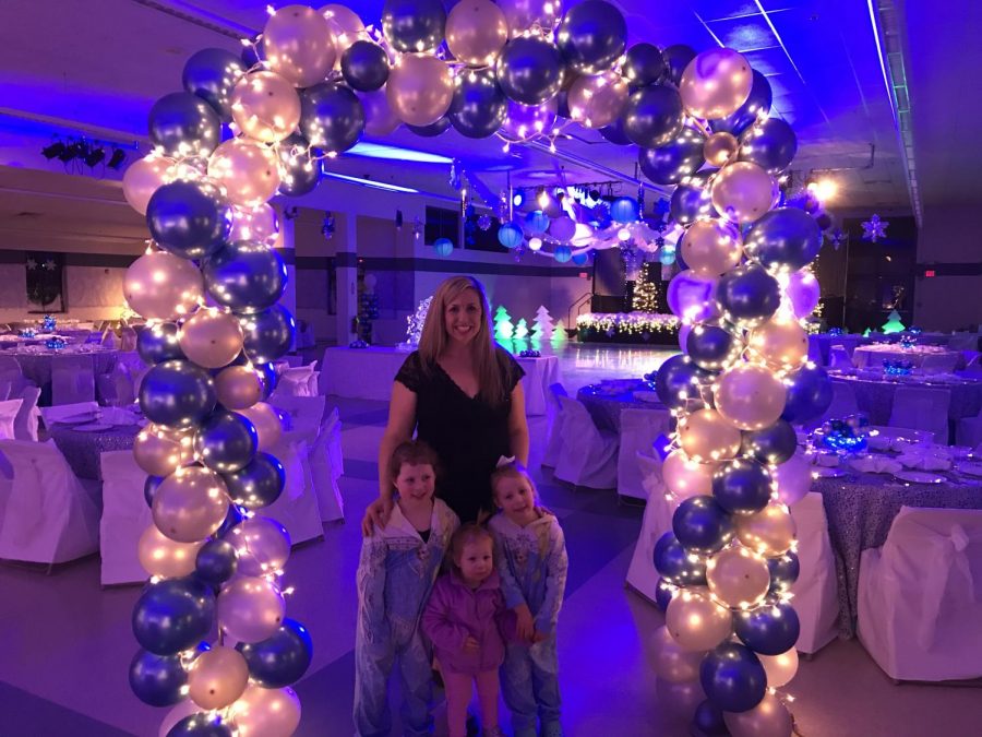 Tebbetts stands with her three daughters at the annual Unifed Snowball. The Snowball is an annual dance for all Unified athletes and helpers.