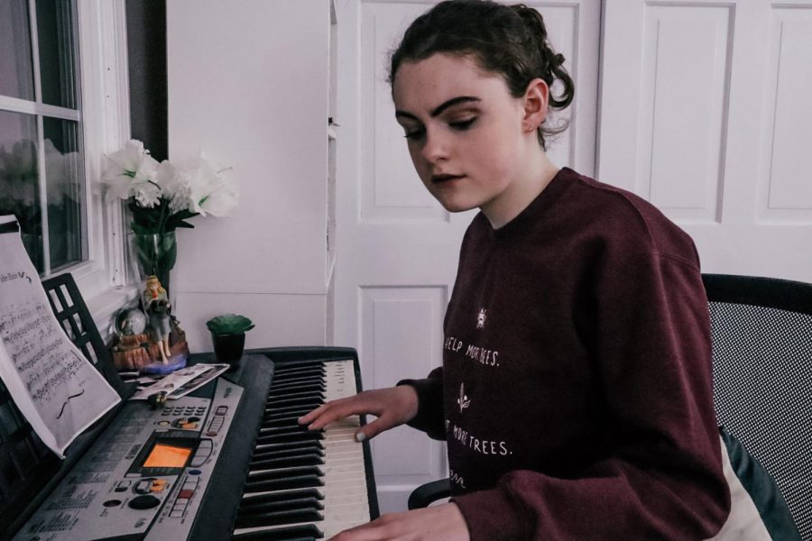 Freshman Michaela Horan sits at the piano, focusing her attention on composing her next piece of music. Having been writing since she young, Horan feels that her music is the best expression of herself.