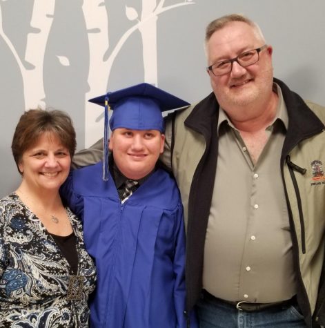 Courtesy of the Sliwerski Family Brenda and John Sliwerski pose with their son Corey after his graduation. The couple started the Corey’s Closet thrift store as a way to help individuals with developmental disabilities like Corey find success in the workforce as young adults.