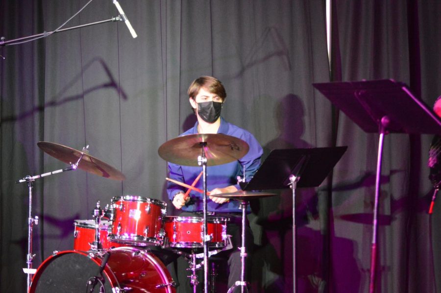Andrew Johnson plays the drums in accompaniment for Chole Ferraro. Johnson accompanied over four acts and performed his own version of Billy Joels hit song, Scenes From an Italian Restaurant at the Prism concert.