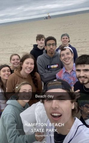 APES students stand on the beach after hours of picking up trash on the shoreline. 