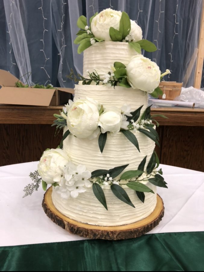 After putting the finishing touches on the cake, Tamanaha brings the dessert to a wedding.