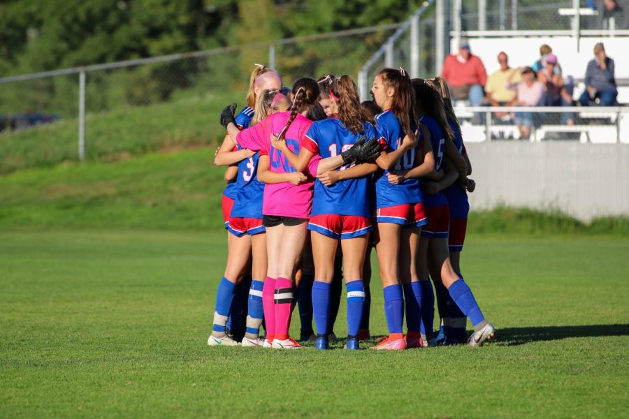 Girls Soccer huddles before game against Hanover.