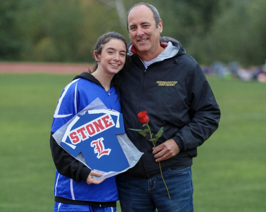 Helper Nicole Stone and her dad celebrate Senior Night.