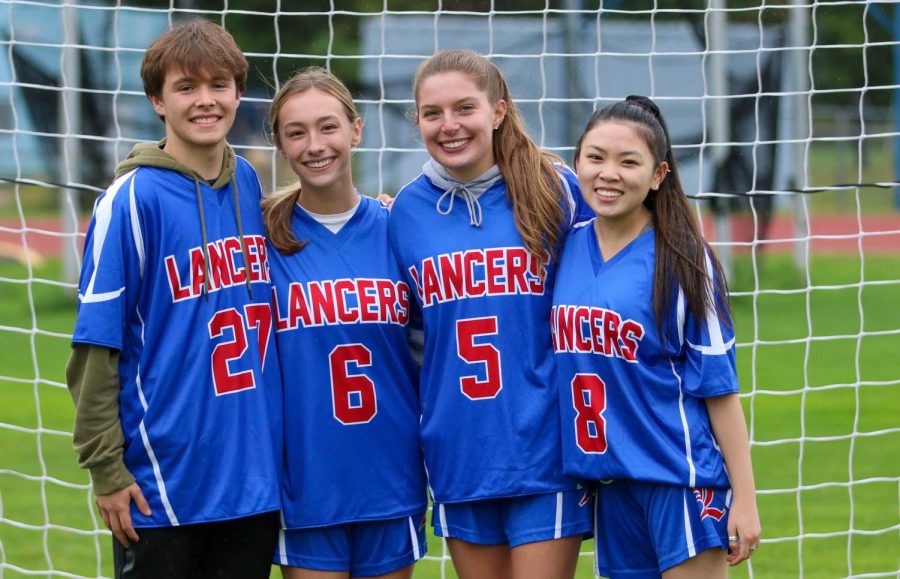 Helpers Mike Williams, Olivia Windisch, Laura Bowen, and Natalie Karlson celebrate Senior Night.