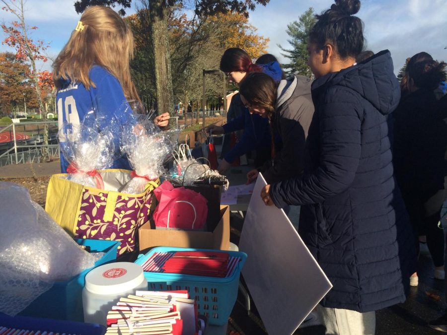 Community Service Club members set up donation and raffle tables before the walk begins.