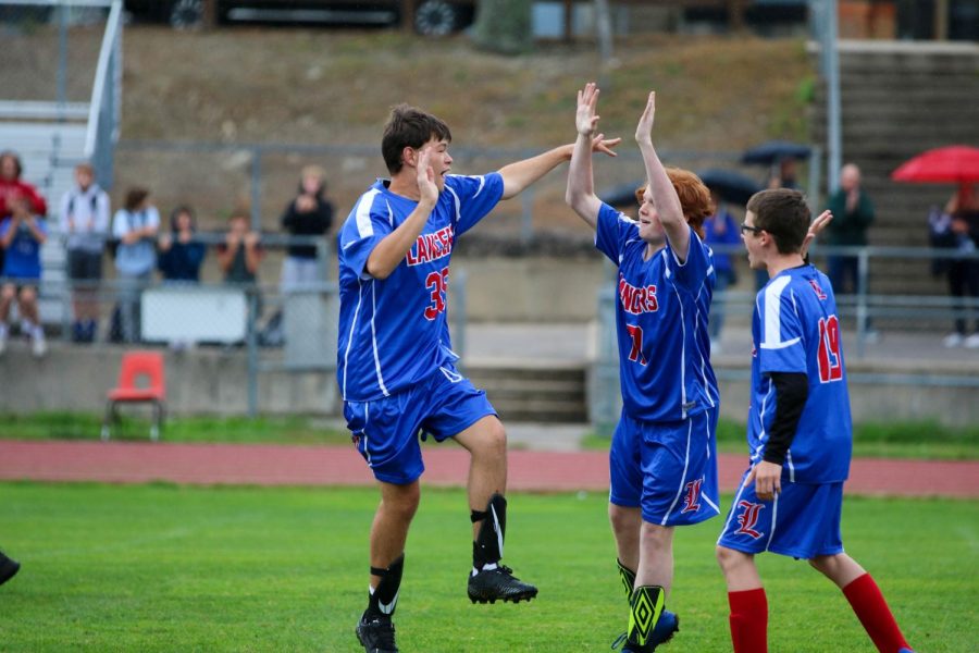 Ben Laverty celebrates with teammates Ryan Batts and Matt Sharrock.