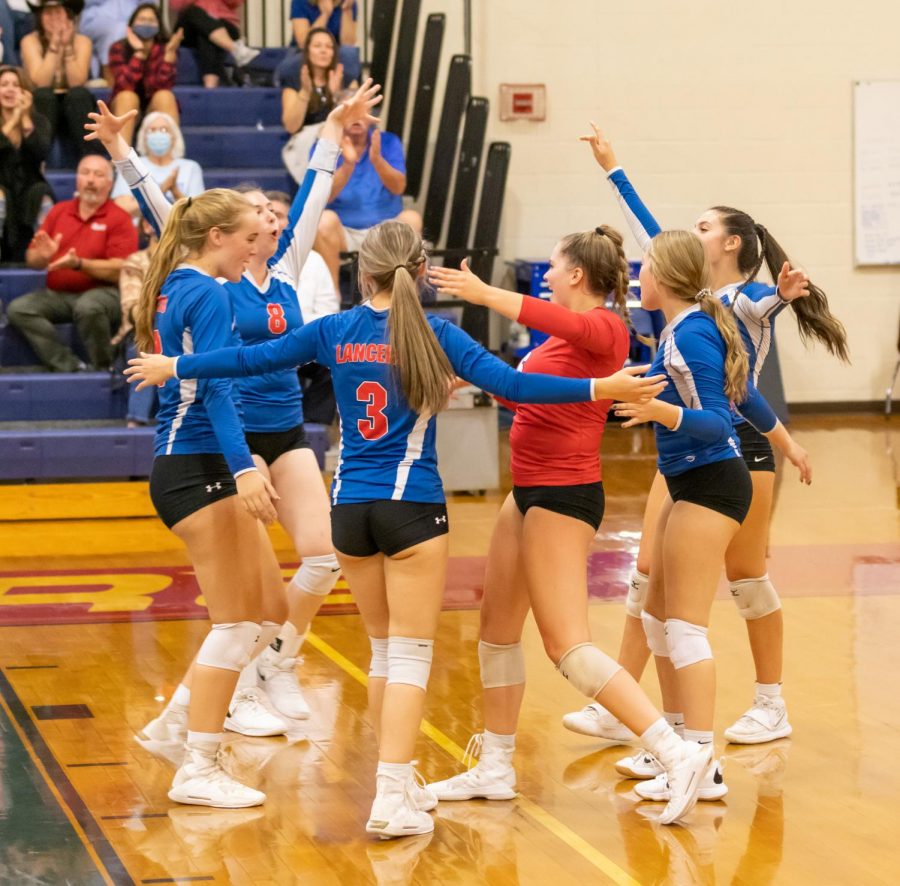 The Girls Varsity Volleyball team celebrates the point and huddles together. This video shows highlights from a previous game. 