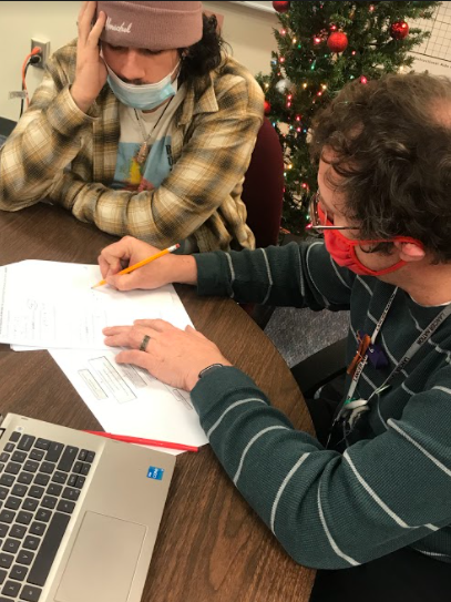Mr. Guertin helps sophomore Nick Strong with math in room 112. His favorite thing is to help students avoid the same mistakes he made. Photo by Gianna Siracuse