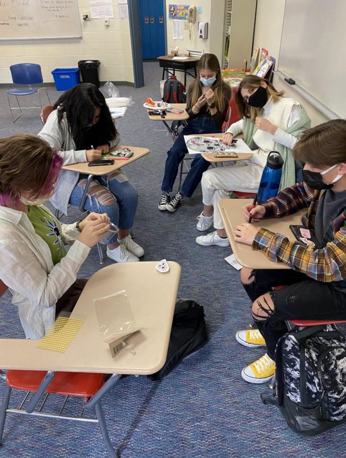  Five members of the International Club coloring in their chosen pictures for the “Day of the Dead” celebration.
