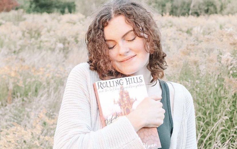 Sophomore Michaela Horan holds in her hands the novel shes been writing since the fourth grade. Rolling Hills and the Lost Key of Peachtree Palace was published in September 2021. 