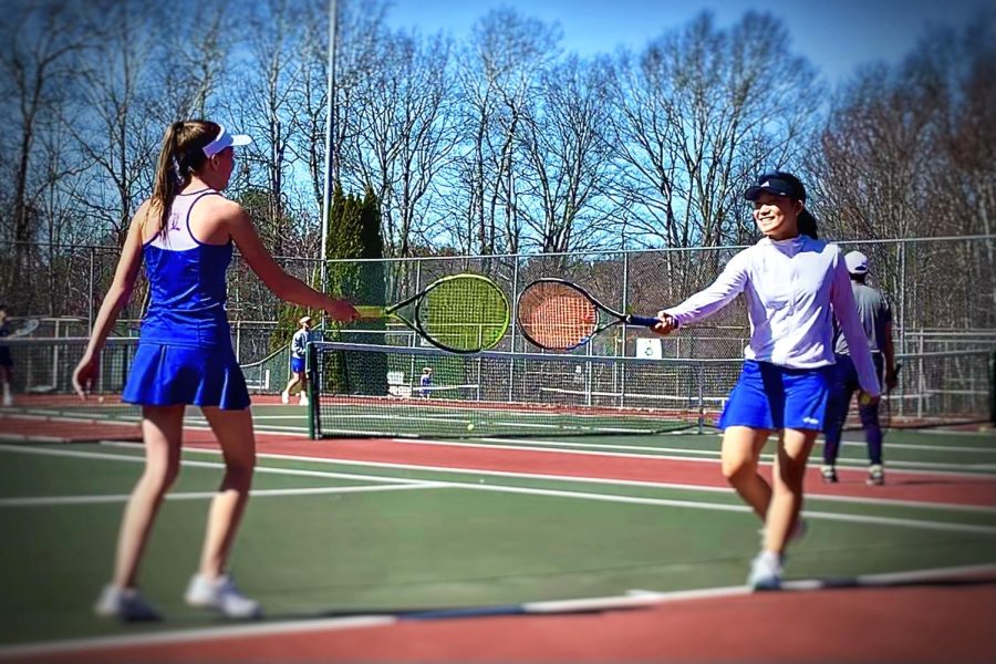 Senior Laura Bowen and junior Susan Kim practice before their first home match. 