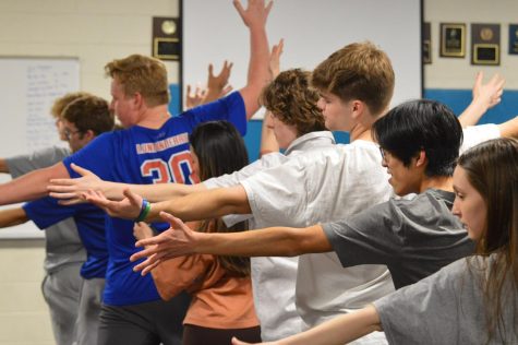 The boys line up during their dance rehearsal.