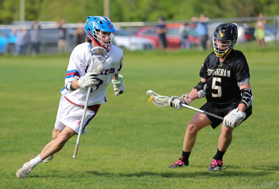 Senior Jack Bierne runs toward the net.