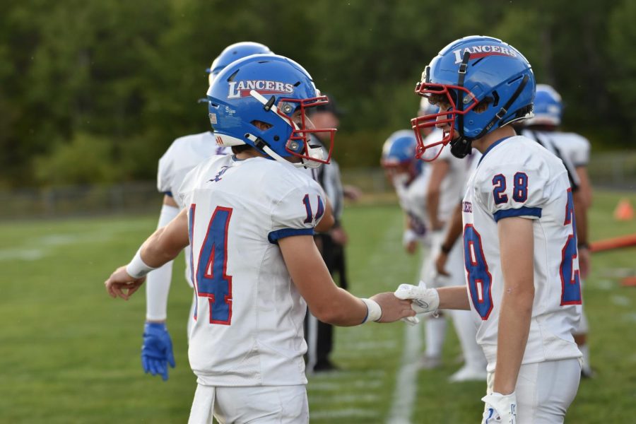 Juinors Conor Williams #14 and Jake Schena #28 communicate before the start of the game. 