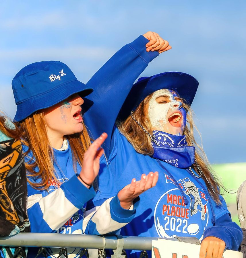 Senior Kathryn Martin (left) and Adriana Quintal (right) cheer on the Lancers at Friday nights football game.