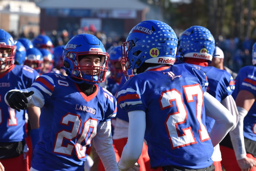 #20 junior Kyle Stebbins and #27 junior Seth Doyon celebrate together after a play.