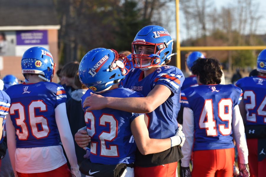 #22 junior Matthew Carroll and #35 sophomore Devin Boles embrace one another in celebration.