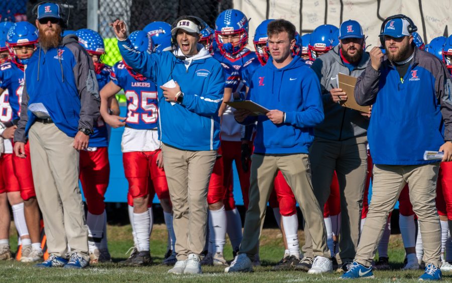 Coach Jimmy Lauzon cheers on his team from the sidelines.