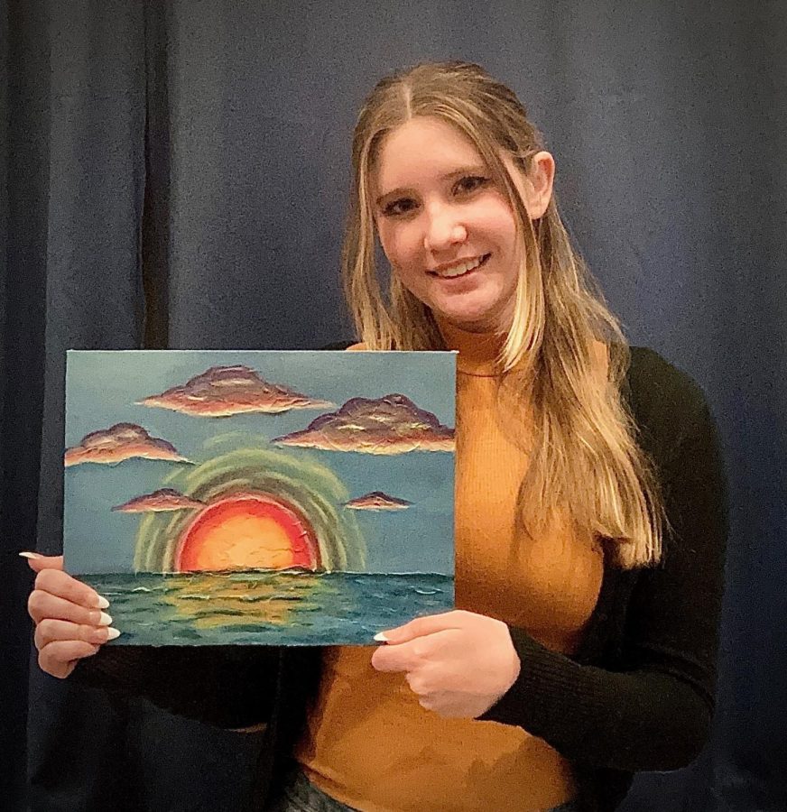 Senior+Danielle+Goodall+proudly+holds+one+of+her+many+art+pieces+on+display.+Goodall+has+been+drawing+since+the+age+of+3+and+plans+to+pursue+a+career+in+graphic+art+after+high+school.