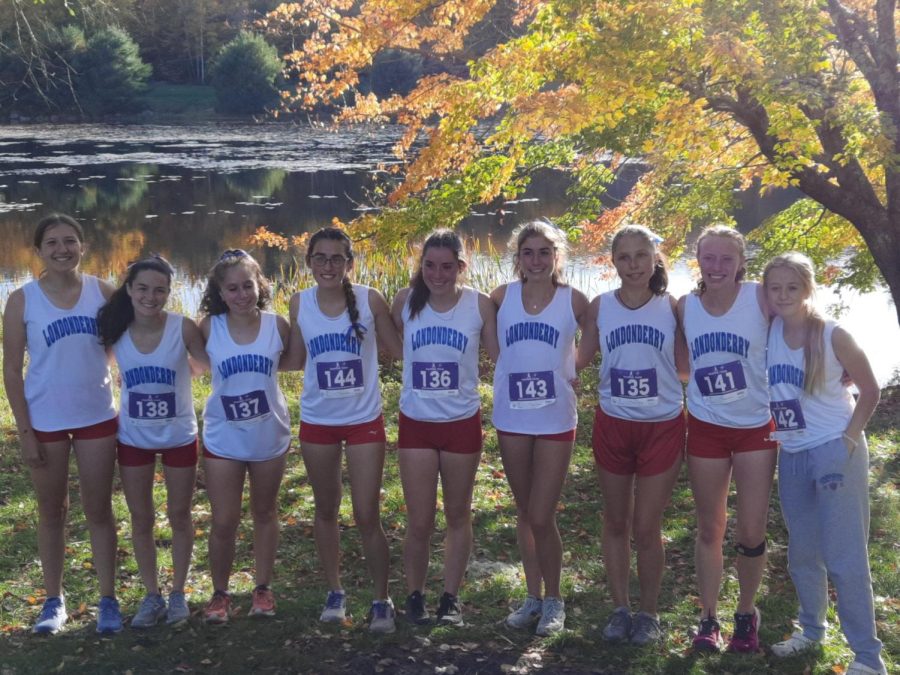 Girls+cross+country+gathers+together+for+a+photo+after+their+meet+at+Amherst.