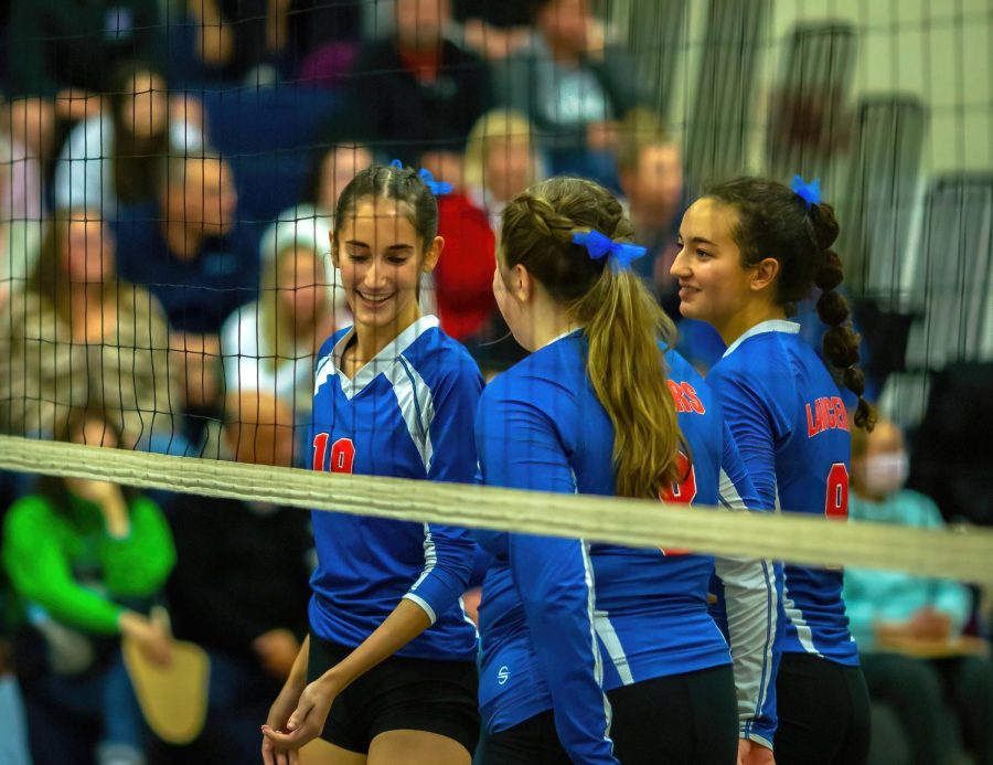 Senior Becca Tinkler and Juniors Olivia Defazio and Ally McGonagle converse during the game.